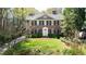 Beautiful brick two-story home with a well manicured green lawn and dark shutters at 1209 The By Ne Way, Atlanta, GA 30306
