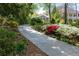 Charming walkway winding through lush gardens and mature trees at 1209 The By Ne Way, Atlanta, GA 30306