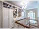 Hallway with beautiful built-in bookshelves and a chandelier, offering lots of storage at 1209 The By Ne Way, Atlanta, GA 30306
