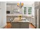 Bright kitchen with granite countertops, stainless appliances, and an island with seating at 1209 The By Ne Way, Atlanta, GA 30306