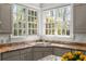 A well-lit kitchen area with granite countertops and lots of natural light from the window at 1209 The By Ne Way, Atlanta, GA 30306