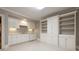 A clean kitchenette featuring white cabinets, plenty of storage, and a stainless steel dishwasher at 1209 The By Ne Way, Atlanta, GA 30306