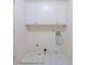 Basic laundry room with upper cabinets and tile flooring provides a functional space for laundry tasks at 1209 The By Ne Way, Atlanta, GA 30306