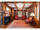Cozy library with wood paneling, built-in bookshelves, a fireplace, and ample seating at 1209 The By Ne Way, Atlanta, GA 30306
