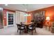 Spacious living room featuring a piano, game table, built-in bookshelves, and a nearby staircase at 1209 The By Ne Way, Atlanta, GA 30306