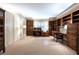Spacious home office with custom wood cabinetry, desk, and shelving for storage and organization at 1209 The By Ne Way, Atlanta, GA 30306