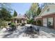 Backyard patio with an American flag, multiple seating areas, and lush landscaping at 1209 The By Ne Way, Atlanta, GA 30306