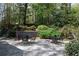 Charming stone patio with multiple seating areas surrounded by lush landscaping at 1209 The By Ne Way, Atlanta, GA 30306