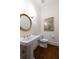 Traditional powder room with pedestal sink, gold accents, and hardwood floors at 1209 The By Ne Way, Atlanta, GA 30306