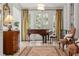 Elegant sitting room with a piano and French doors, offering a serene space at 1209 The By Ne Way, Atlanta, GA 30306