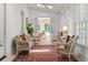 Bright sunroom with wicker furniture, white brick, ceiling fan, and views to another bright room at 1209 The By Ne Way, Atlanta, GA 30306