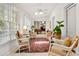Bright and airy sunroom with wicker chairs, ceiling fan, and beautiful natural light at 1209 The By Ne Way, Atlanta, GA 30306