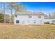 Back of the home featuring a yard with grass, trees, and an exterior elevation at 2560 Ashley Downs Ln, South Fulton, GA 30349