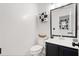Stylish half bath with modern fixtures, toilet paper storage and decorative mirror at 2560 Ashley Downs Ln, South Fulton, GA 30349