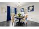 Cozy dining area featuring a round table, patterned chairs, and natural light from the large window at 2560 Ashley Downs Ln, South Fulton, GA 30349