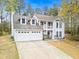 Charming two-story home featuring a two-car garage, inviting balcony, and manicured front yard at 2560 Ashley Downs Ln, South Fulton, GA 30349