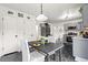 Bright kitchen with gray cabinetry, stainless steel appliances, and small eating table at 2560 Ashley Downs Ln, South Fulton, GA 30349