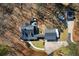 This aerial shows the home with a three-car garage, manicured lawn, and wooded surroundings at 1064 Brooks Rackley Rd, Dallas, GA 30157