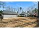 Wide shot of home and garage showing the spacious backyard with gazebo and deck at 1064 Brooks Rackley Rd, Dallas, GA 30157