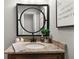 Bathroom vanity with granite countertop, round mirror, and modern fixtures at 1064 Brooks Rackley Rd, Dallas, GA 30157