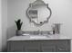 Bright bathroom featuring granite counters, decorative mirror, and gray vanity at 1064 Brooks Rackley Rd, Dallas, GA 30157