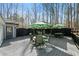 Large wooden deck with multiple seating areas and outdoor umbrellas at 1064 Brooks Rackley Rd, Dallas, GA 30157