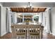 Dining room with wood table, decorative chandelier, and backyard view at 1064 Brooks Rackley Rd, Dallas, GA 30157