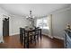 This dining room has white crown molding, hardwood floors, and a modern chandelier at 1064 Brooks Rackley Rd, Dallas, GA 30157