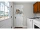 This laundry room has brick floors, a back door, and new washer and dryer at 1064 Brooks Rackley Rd, Dallas, GA 30157