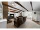 Open living room featuring beamed ceilings, brick fireplace, and lots of natural light at 1064 Brooks Rackley Rd, Dallas, GA 30157