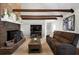 Cozy living room featuring a fireplace, wooden beams and comfortable seating at 1064 Brooks Rackley Rd, Dallas, GA 30157