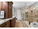 This main bathroom features a glass enclosed shower and soaking tub, all with stone tile at 1064 Brooks Rackley Rd, Dallas, GA 30157