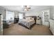 This main bedroom features a decorative fireplace, soft carpet, and a view to the main bath at 1064 Brooks Rackley Rd, Dallas, GA 30157