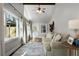 Bright sun room with many windows, hardwood floors, and wooden beam accents at 1064 Brooks Rackley Rd, Dallas, GA 30157