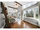 Bright sun room with many windows, hardwood floors, and wooden beam accents at 1064 Brooks Rackley Rd, Dallas, GA 30157