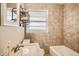 Bathroom with tiled walls, granite vanity, and modern fixtures at 2567 Connally Dr, East Point, GA 30344