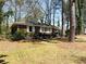 Brick house with white trim, surrounded by lush greenery and mature trees at 2567 Connally Dr, East Point, GA 30344