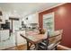 Bright eat-in kitchen with white cabinets, stainless appliances, and a wooden dining table set at 2567 Connally Dr, East Point, GA 30344