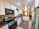 Spacious kitchen featuring white cabinetry, stainless appliances, tile backsplash, and tile floor at 2567 Connally Dr, East Point, GA 30344