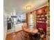 Open eat-in kitchen with wooden table and seating, next to custom shelving unit at 2567 Connally Dr, East Point, GA 30344