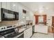 Well-lit kitchen with stainless sink, white cabinets, tile backsplash, and tile floors at 2567 Connally Dr, East Point, GA 30344