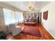 Cozy living room with hardwood floors, a leather sofa, and a large bookcase at 2567 Connally Dr, East Point, GA 30344
