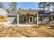 Spacious backyard with a covered patio and ceiling fan, perfect for relaxing and entertaining at 5328 Monticello Dr, Villa Rica, GA 30180