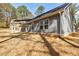 Spacious backyard with a covered patio, ceiling fan, and lovely view of the trees at 5328 Monticello Dr, Villa Rica, GA 30180