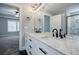 Bathroom with a double sink vanity, large mirror, and a view into the bedroom at 5328 Monticello Dr, Villa Rica, GA 30180