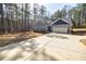 Lovely gray home featuring a long driveway, two-car garage, and inviting curb appeal at 5328 Monticello Dr, Villa Rica, GA 30180