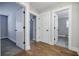 Hallway featuring hardwood flooring, white trim and access to a bathroom and bedroom at 5328 Monticello Dr, Villa Rica, GA 30180
