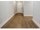 Hallway with wood-look flooring, white trim and neutral walls at 5328 Monticello Dr, Villa Rica, GA 30180