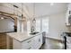 Bright, open kitchen with granite island, stainless appliances, and stylish pendant lighting at 5328 Monticello Dr, Villa Rica, GA 30180