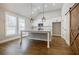 Kitchen with white cabinets, granite counters, hardwood floor and a large island at 5328 Monticello Dr, Villa Rica, GA 30180